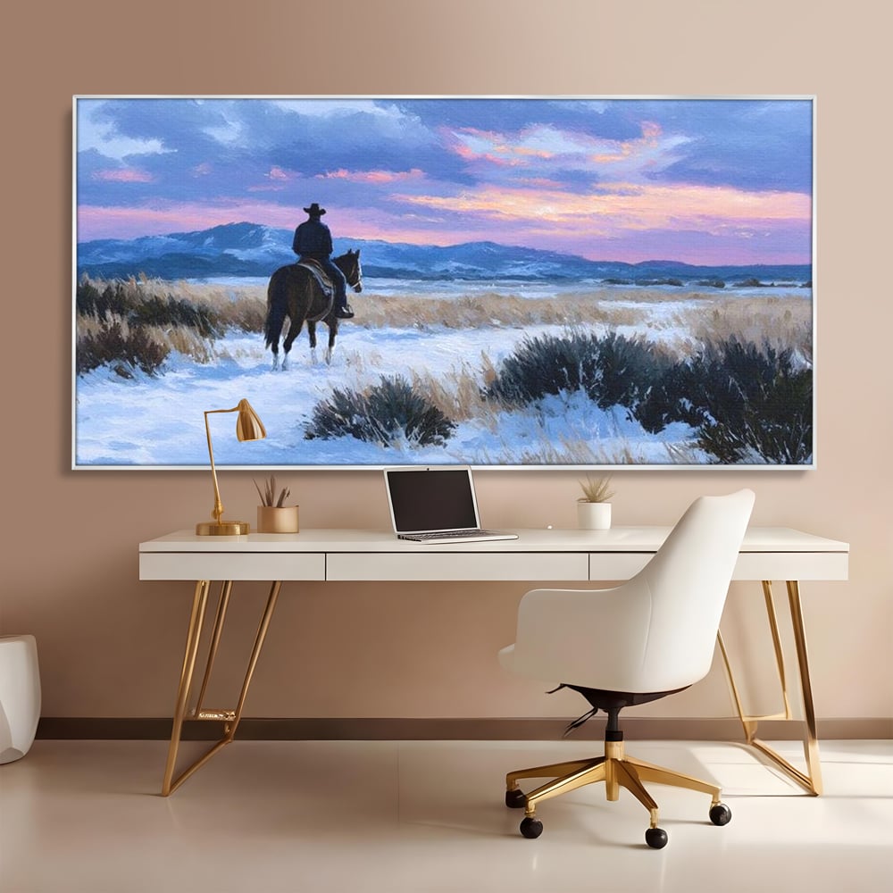 Tablou canvas cu pictura cu calaret cowboy in zapada, in rama de aluminiu argintiu, pe perete intr-un birou
